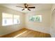 Bright bedroom with hardwood floors, a ceiling fan, and abundant natural light from two large windows at 2954 37Th N Ave, St Petersburg, FL 33713