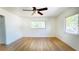 Bedroom with hardwood floors, a ceiling fan, and a window offering natural light and a view to the outside at 2954 37Th N Ave, St Petersburg, FL 33713