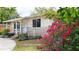 Charming single-story home showcasing colorful bougainvillea, front yard landscaping, and a paved driveway at 2954 37Th N Ave, St Petersburg, FL 33713