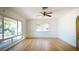 Bright living room featuring hardwood floors, a ceiling fan, and ample natural light from large windows at 2954 37Th N Ave, St Petersburg, FL 33713