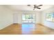 Bright living room with wood floors, fan, and large windows offering ample natural light at 2954 37Th N Ave, St Petersburg, FL 33713