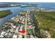 Aerial view of home on canal near large body of water with many boats and residential areas at 3215 W Shell Point Rd, Ruskin, FL 33570