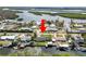 Aerial view of home on canal with docks and a large body of water with residential area at 3215 W Shell Point Rd, Ruskin, FL 33570