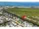 Aerial view of a waterfront home with boat dock on canal leading to a large body of water at 3215 W Shell Point Rd, Ruskin, FL 33570