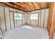 Bedroom featuring exposed block walls and wood framing, awaiting your personal design touches at 3215 W Shell Point Rd, Ruskin, FL 33570