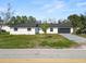 Charming single story home with a gray two car garage and well-manicured lawn at 3215 W Shell Point Rd, Ruskin, FL 33570