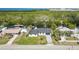 Exterior shot of a single-story home on a canal, featuring a private boat dock at 3215 W Shell Point Rd, Ruskin, FL 33570