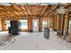 Spacious living room featuring unfinished walls and ceiling with an exterior door and windows at 3215 W Shell Point Rd, Ruskin, FL 33570