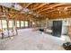 Large living room featuring unfinished walls and ceiling with windows on the adjacent walls at 3215 W Shell Point Rd, Ruskin, FL 33570