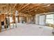 Spacious living room featuring unfinished walls and ceiling with an exterior door and windows at 3215 W Shell Point Rd, Ruskin, FL 33570