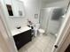 Bathroom featuring a single vanity with a dark wood cabinet, a toilet and shower at 3415 Phillips St, Tampa, FL 33619