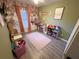 Whimsical bedroom with hardwood floors, ample natural light, and dedicated toy storage at 3415 Phillips St, Tampa, FL 33619