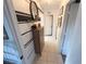 Hallway featuring a decorative wall treatment, and a neutral colored storage cabinet at 3415 Phillips St, Tampa, FL 33619