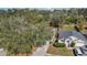 This aerial view shows a charming home with a well-maintained yard, a long driveway and mature trees at 530 Napa Valley Cir, Valrico, FL 33594