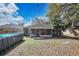 This backyard features a refreshing above-ground pool and a screened-in patio, perfect for enjoying the outdoors at 530 Napa Valley Cir, Valrico, FL 33594