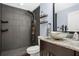 Modern bathroom with a glass vessel sink, granite countertops, a rainfall shower, and black tiled shower walls at 530 Napa Valley Cir, Valrico, FL 33594