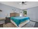 Bedroom with a large bed, ceiling fan, and windows overlooking the backyard at 530 Napa Valley Cir, Valrico, FL 33594