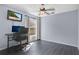 Bedroom with a desk, TV, ceiling fan, and window overlooking the side yard at 530 Napa Valley Cir, Valrico, FL 33594