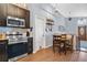 Kitchen area featuring stainless steel appliances, dark wood cabinets, and breakfast nook at 530 Napa Valley Cir, Valrico, FL 33594