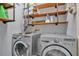 Laundry room with a washer, dryer, and shelving at 530 Napa Valley Cir, Valrico, FL 33594