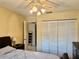 Bedroom featuring closet with louvered doors, fan lighting and an open doorway at 11231 Dollar Lake Dr # 1, Port Richey, FL 34668