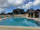 Enjoy the community pool with plenty of seating on a beautiful sunny day at 11231 Dollar Lake Dr # 1, Port Richey, FL 34668