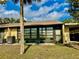 View of the house exterior with sliding glass door and window at 11231 Dollar Lake Dr # 1, Port Richey, FL 34668