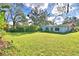 Expansive backyard showcasing a well-maintained lawn and mature trees, creating a peaceful outdoor retreat at 1413 May St, Lutz, FL 33548