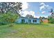 Cozy home featuring a spacious backyard, perfect for outdoor relaxation and entertaining at 1413 May St, Lutz, FL 33548