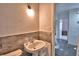 Bathroom featuring a white sink with a marble backsplash and a white toilet at 1413 May St, Lutz, FL 33548