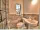 Bathroom featuring a white sink with a marble backsplash, and a white toilet at 1413 May St, Lutz, FL 33548