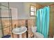 Standard bathroom featuring a pedestal sink and shower with a blue curtain at 1413 May St, Lutz, FL 33548