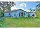 Charming exterior view of home showing the side yard with mature landscaping at 1413 May St, Lutz, FL 33548