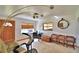 Bright living room featuring tiled floors, a unique light fixture and a large window at 1413 May St, Lutz, FL 33548