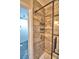 Shower with marble tile walls, a sliding glass door and a soap basket at 1413 May St, Lutz, FL 33548