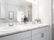 Bright bathroom boasts a double vanity with elegant marble countertops and modern fixtures at 2763 Walden Town Cir, Plant City, FL 33566