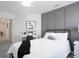 Bedroom with neutral colors featuring decorative panel wall, desk and guest décor at 2763 Walden Town Cir, Plant City, FL 33566