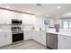 Modern kitchen featuring stainless steel appliances, white cabinets, light countertops and hardwood flooring at 2763 Walden Town Cir, Plant City, FL 33566