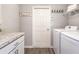 Functional laundry room with a countertop, cabinets, a washing machine, a dryer, and rustic decor at 7077 162Nd E Pl, Parrish, FL 34219