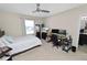 Bright bedroom featuring a full bed, desk, and modern ceiling fan at 8680 Falling Blue Pl, Riverview, FL 33578