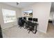 Bright bedroom features a ceiling fan, a window, and dedicated workstation areas at 8680 Falling Blue Pl, Riverview, FL 33578