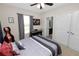 Cozy bedroom featuring a ceiling fan, gray bedding, and a musical keyboard at 8680 Falling Blue Pl, Riverview, FL 33578