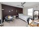 Bedroom with a brown accent wall, chair, and desk at 8680 Falling Blue Pl, Riverview, FL 33578