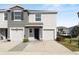 Inviting townhome exterior with a two-car garage and well-maintained landscaping at 8680 Falling Blue Pl, Riverview, FL 33578