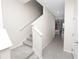 Bright, neutral hallway with staircase leading to the upper level and tiled flooring at 8680 Falling Blue Pl, Riverview, FL 33578