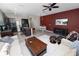 Open concept living room view with kitchen, dining, and comfortable seating on white rug at 8680 Falling Blue Pl, Riverview, FL 33578