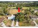 Aerial view of house with arrow pointing to it in a field with large trees at 9608 Theresa Dr, Thonotosassa, FL 33592