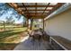 Outdoor backyard patio featuring a dining table set and a wooden pergola at 9608 Theresa Dr, Thonotosassa, FL 33592