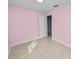 Bedroom features soft pink walls, light-colored tile flooring, and ample natural light at 9608 Theresa Dr, Thonotosassa, FL 33592