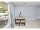 Bright dining area featuring neutral wall color, lots of light, and tile flooring at 9608 Theresa Dr, Thonotosassa, FL 33592